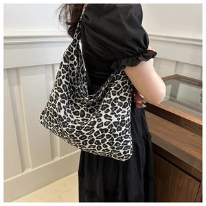 Detail of a chic leopard print canvas hobo bag showing large capacity and thick fabric