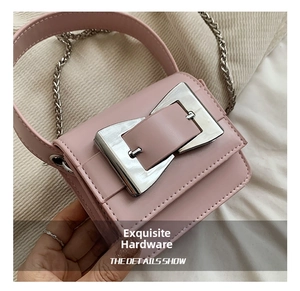 Close-up of pink mini bag featuring a textured finish and oversized silver square buckle
