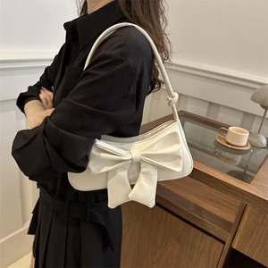 Elegant white faux leather shoulder bag with a large bow detail for chic summer outfits