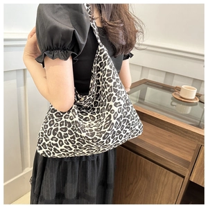 Fashionable black and white leopard print tote bag shown on model for daily styling