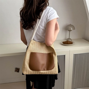 Minimalist woven straw tote bag with brown leather pocket and rope straps for summer style
