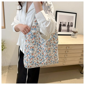Floral canvas tote bag details showing blue and orange patterns on a casual shoulder bag