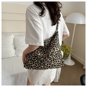 Detailed view of large leopard print tote bag styled in a modern minimalist interior