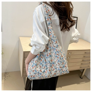 Detailed back view of a floral hobo tote bag worn over the shoulder for daily style