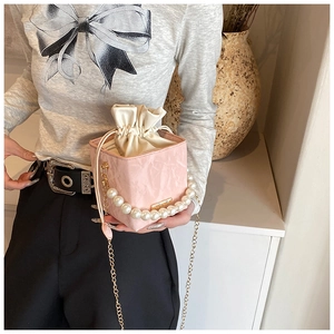 Pink cube chain bag with large pearl handle and satin drawstring inner detail