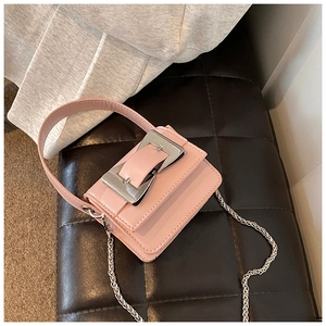 Detail of light pink mini square bag with silver metal buckle and chain strap