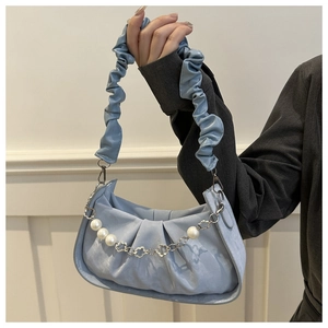 Light blue pleated handbag featuring a decorative pearl and floral silver chain detail