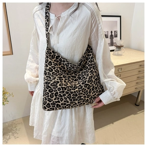 Close-up of leopard print nylon tote bag texture and spacious shoulder strap design