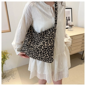 Detailed view of leopard print nylon tote bag with thick shoulder strap for daily casual style