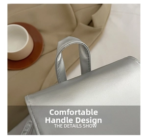 Detail of comfortable silver leather handle with metallic texture on a fashion backpack