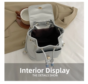 Internal structure of silver metallic drawstring backpack with fabric lining and pocket