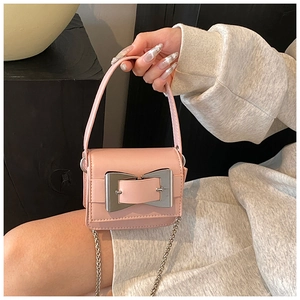 Detailed shot of pink PU leather mini bag featuring a silver bow metal clasp and chain