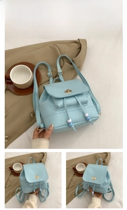 Detail of light blue mini backpack showing gold hardware, twist lock and drawstring