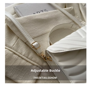 Close-up of beige quilted bag with adjustable golden buckle and refined stitch detail