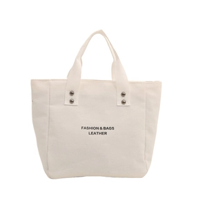 Minimalist beige canvas tote bag with letter print and metal rivet reinforced handles