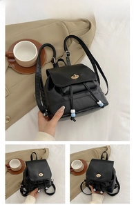 Detail of black mini PU leather backpack with gold twist lock and beaded drawstring