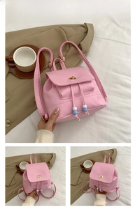 Detailed view of mini pink nylon backpack with drawstring and metal twist lock