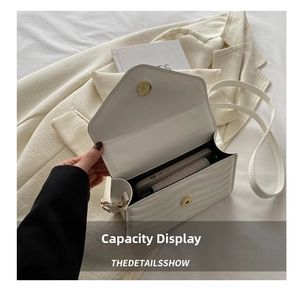 Internal capacity of the white pleated leather crossbody bag showing space for a phone