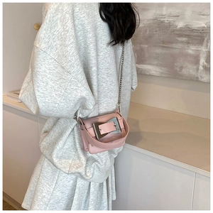 Close-up of pink leather crossbody bag with silver square buckle and chain strap