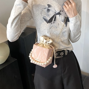 Pink pleated bucket bag with pearl handle and golden chain strap for women