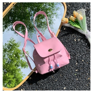 Detail of pink mini leather backpack with gold clasp and decorative bead drawstring