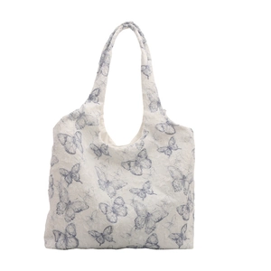 White lace tote bag with blue butterfly pattern and minimalist aesthetics for women