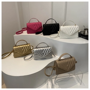Detailed display of V-quilted envelope handbags in six colors with adjustable straps