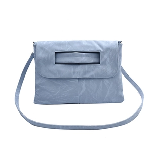 Minimalist light blue envelope handbag with pleated texture and cutout handle
