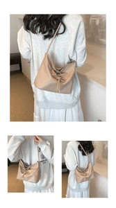 Detail of apricot shoulder bag with drawstring bow and smooth texture on soft leather