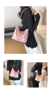 Detail of pink PU leather hobo bag with drawstring bow and smooth texture finish