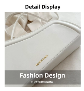 Close-up of golden Fashion & Bags logo on minimalist white leather shoulder bag detail