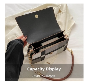 Close-up of plaid shoulder bag interior featuring dual compartments and magnetic gold clasp