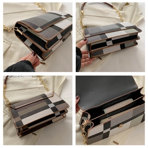 Detail view of plaid underarm bag showing multi-compartment structure and gold chain strap