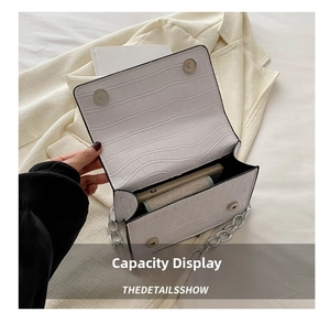 Open view of white crocodile pattern crossbody bag showing internal storage capacity