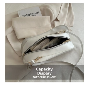 Internal view of the white minimalist handbag showing spacious capacity for daily essentials