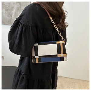 Classic plaid shoulder bag with gold chain strap worn by model for daily commute