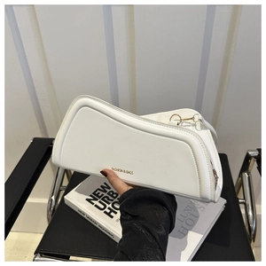 Close-up of cream geometric handbag with gold logo and premium synthetic leather texture