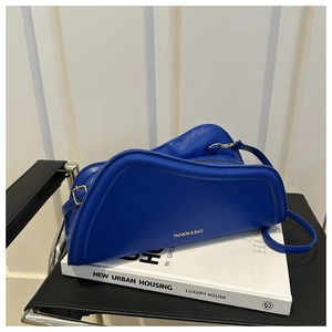 Close-up of Klein Blue crescent shoulder bag with golden FASHION & BAGS lettering