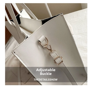 Detail of adjustable gold buckle and fine stitching on white faux leather tote bag
