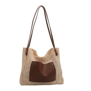 Minimalist summer straw tote bag with brown leather pocket and long shoulder straps