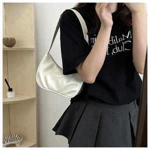 Close-up of a white glossy underarm bag with pleated texture and oval embossed logo