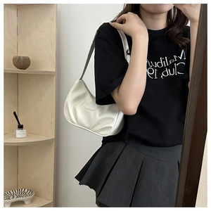 Mirror selfie showing the white crescent underarm bag with a glossy pleated finish