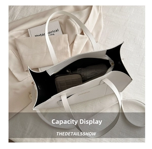 Interior view showing the large capacity of the white tote bag with daily essentials