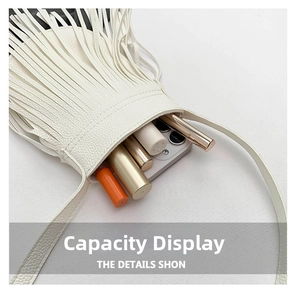 Internal capacity of white fringed crossbody bag showing space for phone and lipsticks