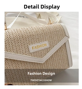 Detail of straw woven flap bag with white leather trim and golden FASHION metal plate