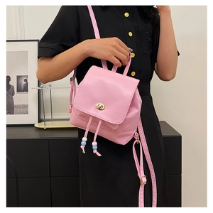 Detail of pink mini backpack with gold twist lock and beaded drawstring decoration
