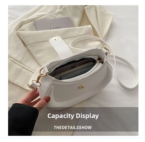 White crescent PU leather bag detail showing interior space for phone and wallet