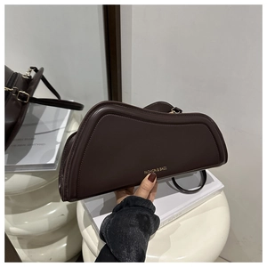 Detail of dark brown leather handbag with curved shape and FASHION & BAGS logo