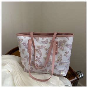 Detailed embroidery of purple butterfly patterns on white canvas tote bag for women