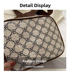 Détails du motif monogramme trèfle sur un sac bandoulière crème avec sangle marron
